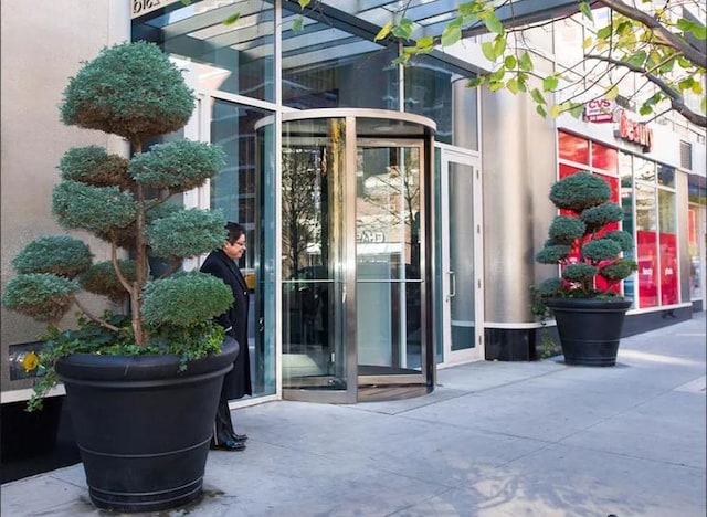 entrance to property featuring stucco siding