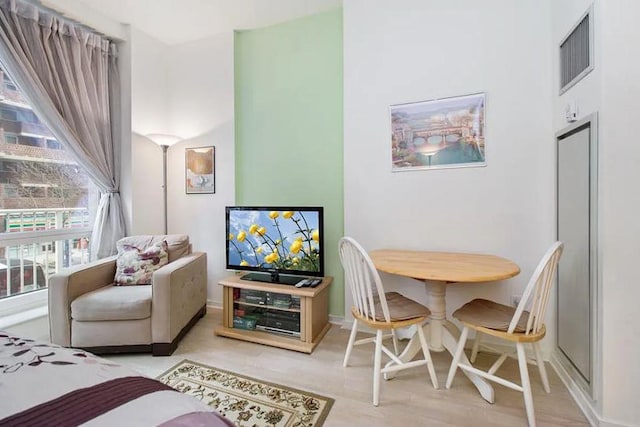 interior space featuring light wood finished floors, visible vents, and baseboards