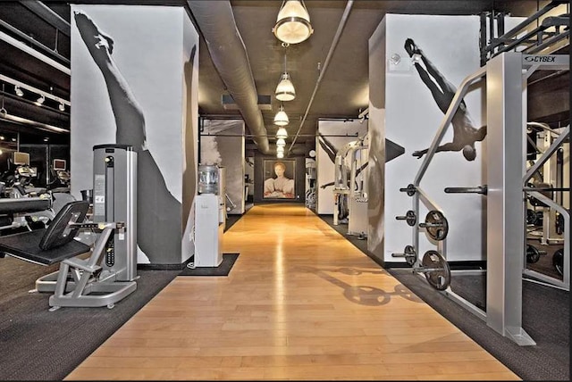 exercise room featuring wood finished floors