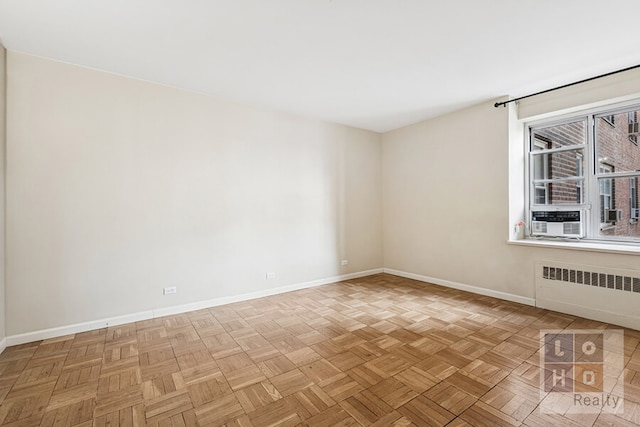 empty room with baseboards and radiator