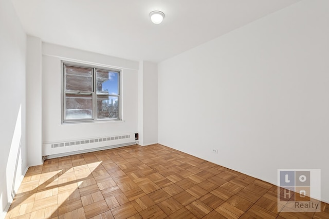 spare room featuring a baseboard heating unit