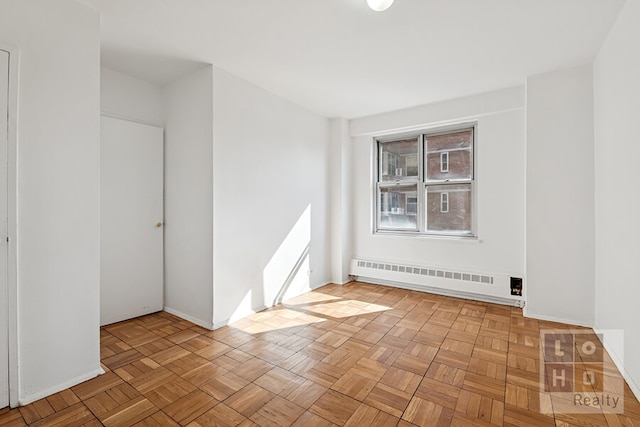 spare room featuring a baseboard radiator and baseboards