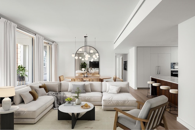 living room with light wood-style floors and an inviting chandelier