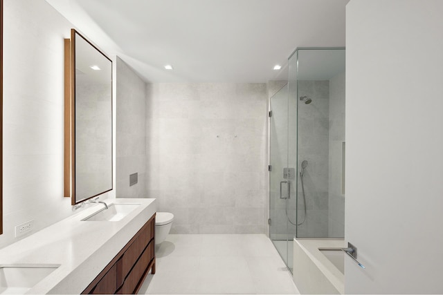bathroom featuring double vanity, a sink, and a stall shower