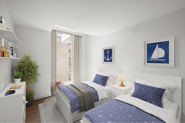 bedroom with baseboards and wood finished floors