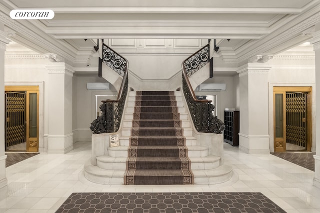 staircase with visible vents, a wall unit AC, crown molding, and ornate columns