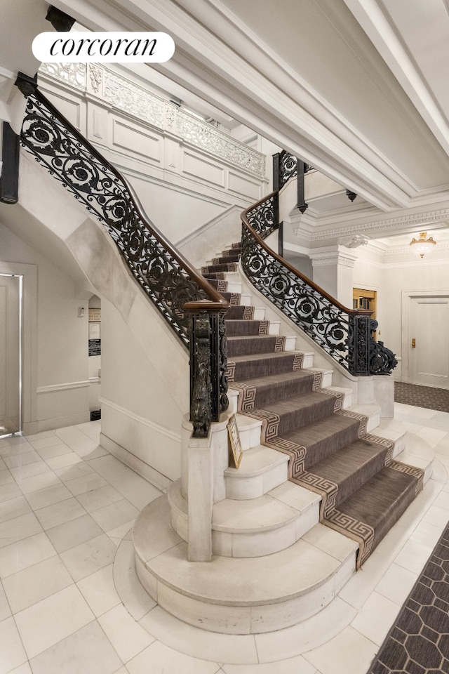 stairs with crown molding and baseboards