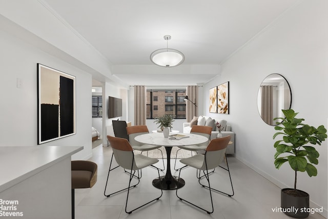 dining area with baseboards and ornamental molding