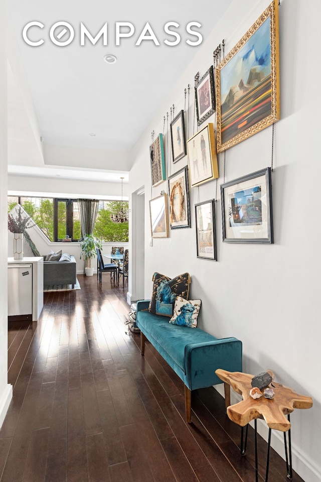 hallway featuring baseboards and wood finished floors