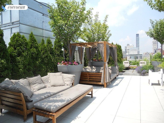 view of patio featuring an outdoor hangout area, a pergola, and a city view
