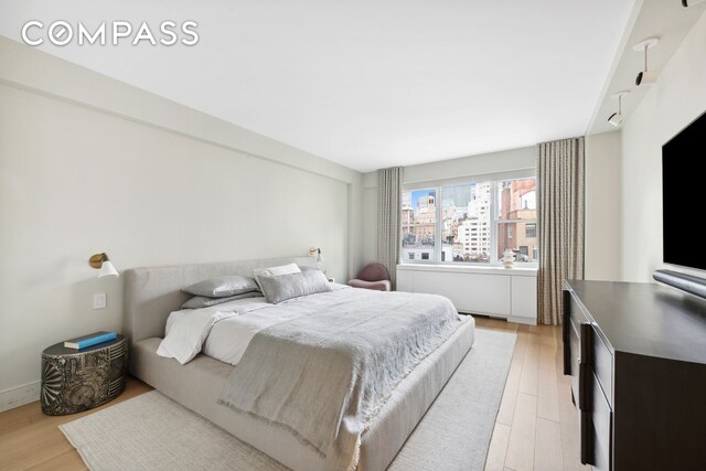 bedroom with light wood finished floors