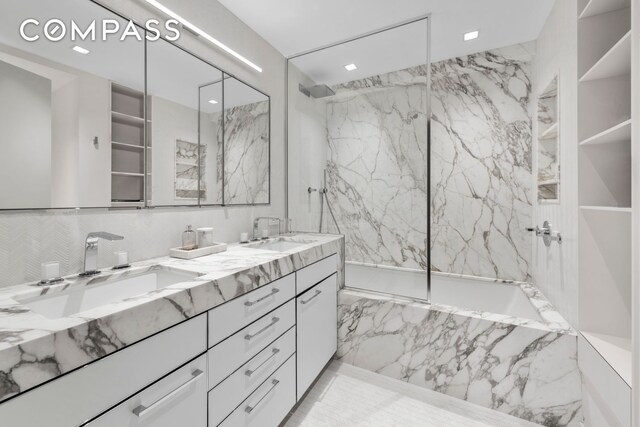 full bathroom with a combined bath / shower with marble appearance, a sink, marble finish floor, and double vanity