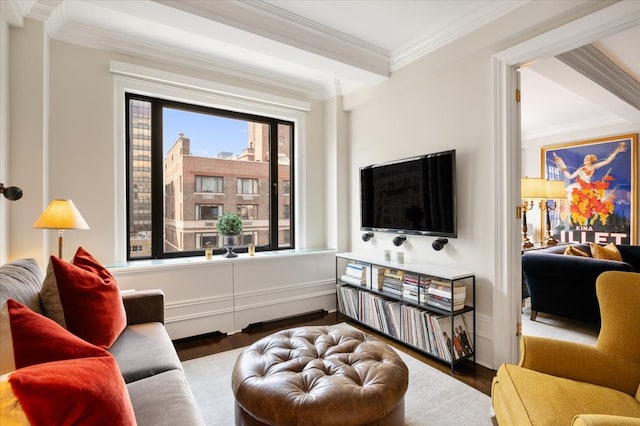 living area with ornamental molding, baseboards, and wood finished floors