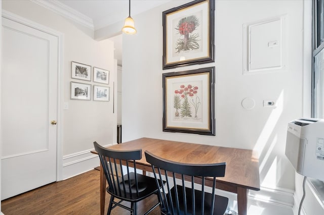 dining space with baseboards, dark wood-type flooring, and crown molding