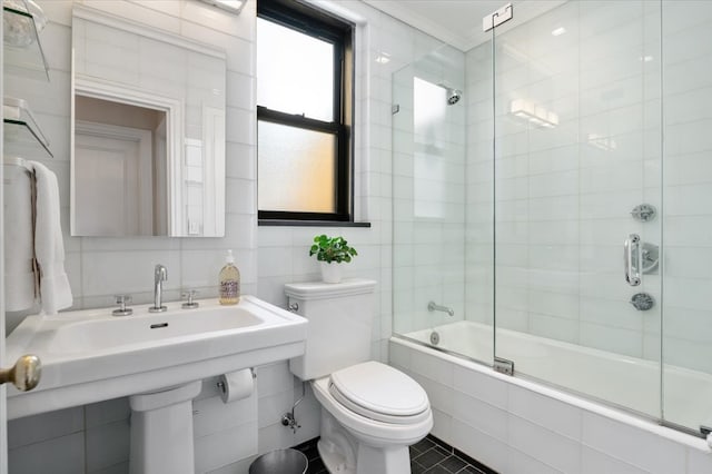 bathroom with toilet, tiled shower / bath combo, tile walls, ornamental molding, and tasteful backsplash