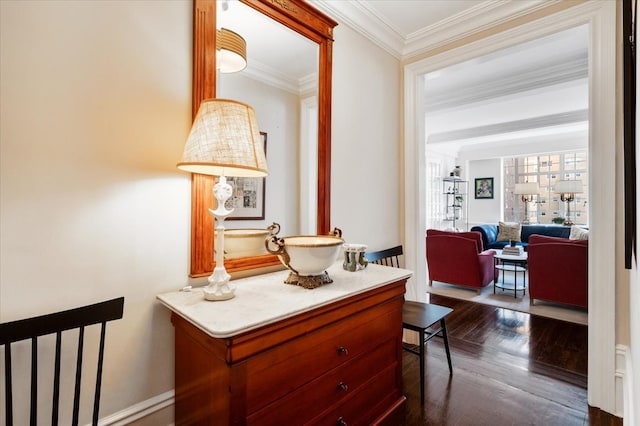 hallway featuring dark wood-style floors, crown molding, and baseboards