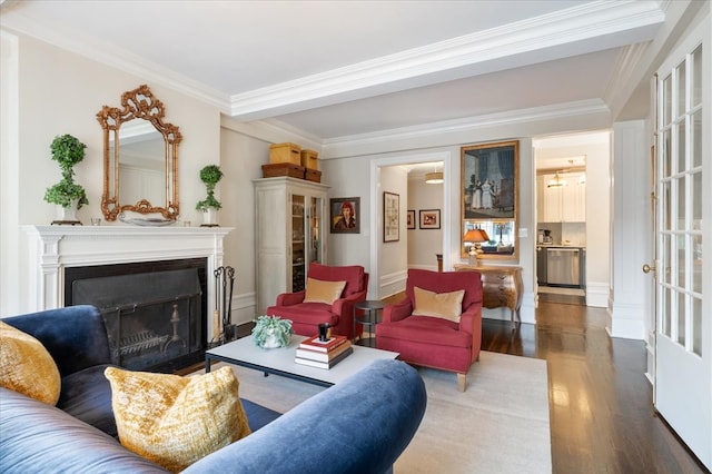 living room with a fireplace with flush hearth, ornamental molding, and wood finished floors