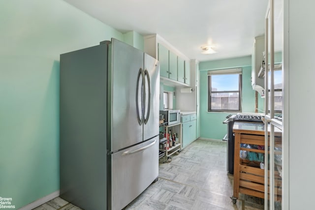 kitchen with baseboards and appliances with stainless steel finishes