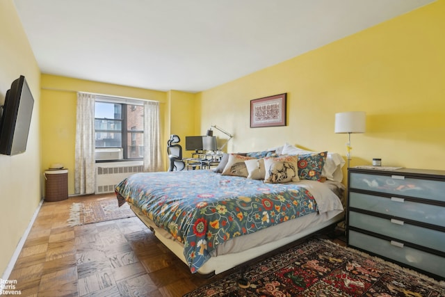 bedroom with radiator heating unit and baseboards