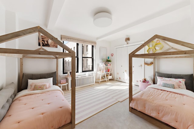 carpeted bedroom with lofted ceiling with beams and radiator heating unit