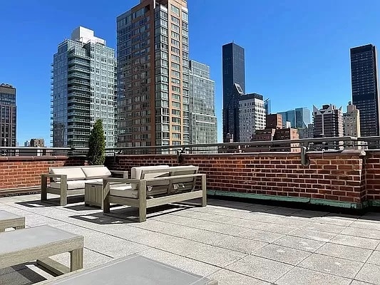 view of patio / terrace with an outdoor living space and a view of city