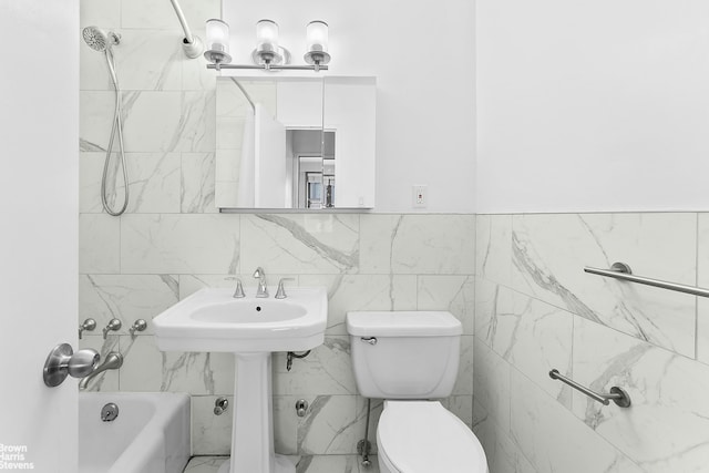 bathroom with shower / bathing tub combination and toilet