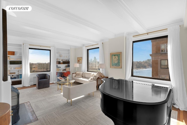 living area with built in features, beamed ceiling, visible vents, and ornamental molding