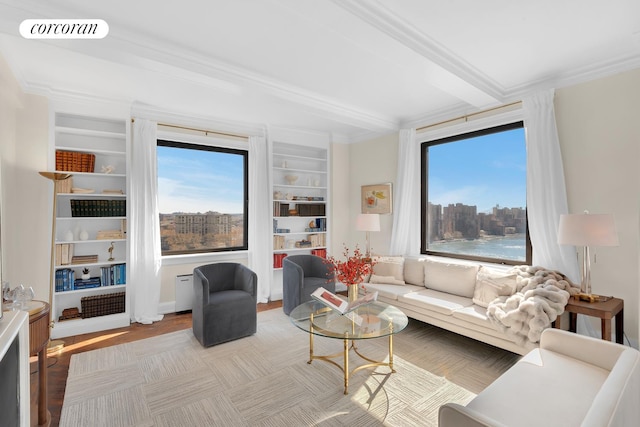 living area with a healthy amount of sunlight, crown molding, visible vents, and beamed ceiling