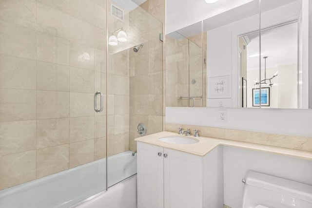 bathroom featuring bath / shower combo with glass door, toilet, and vanity