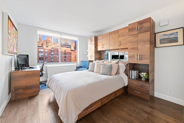 bedroom with dark wood-style flooring and baseboards