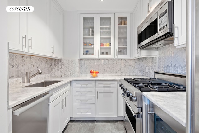 kitchen with a sink, white cabinets, and stainless steel appliances
