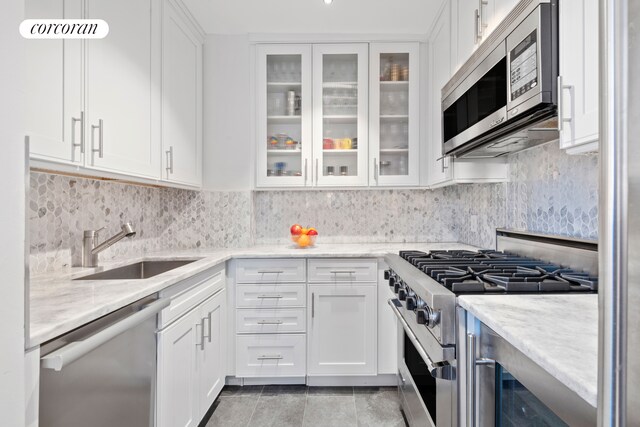 21 S End Ave Unit 722, New York City, NY 10280 - kitchen with a sink, white cabinets, and stainless steel appliances