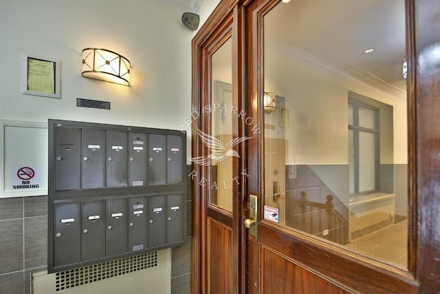 interior space with ornamental molding and mail area
