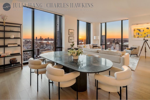 dining space featuring wood finished floors and floor to ceiling windows