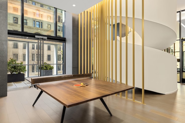 common area with a high ceiling, floor to ceiling windows, and recessed lighting