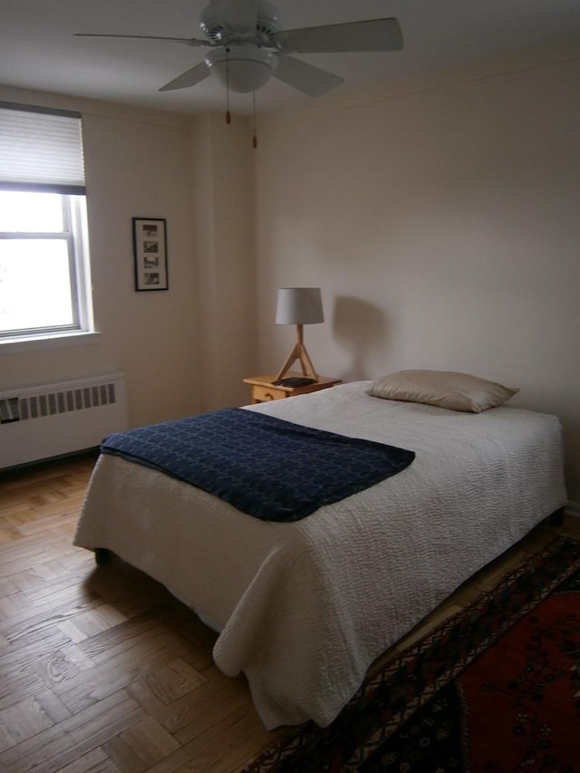 bedroom featuring ceiling fan and radiator heating unit