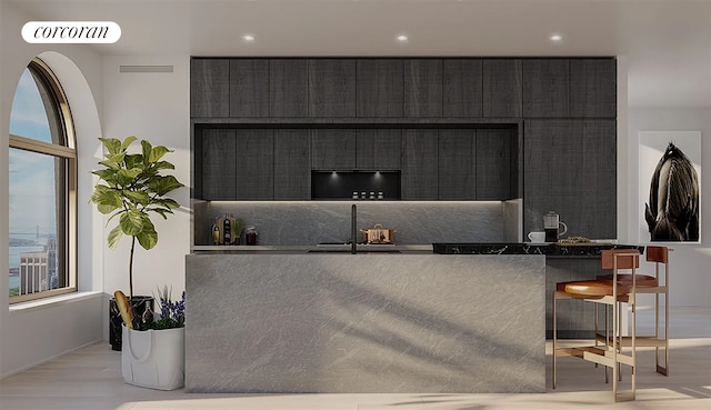 reception area featuring a fireplace, a sink, and visible vents