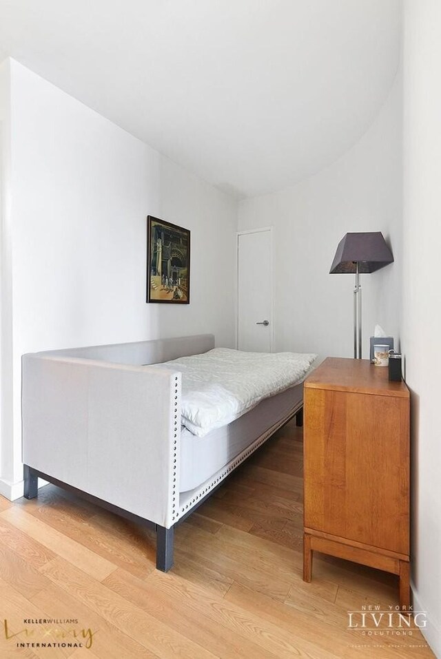 330 E 38th St Unit 24A, New York City, NY 10016 - bedroom featuring wood finished floors and baseboards