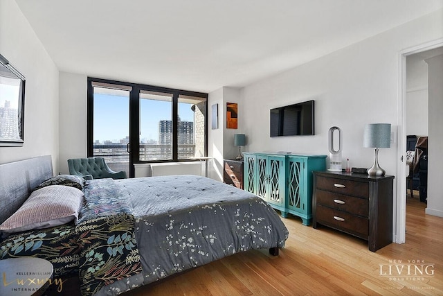 330 E 38th St Unit 24A, New York City, NY 10016 - bedroom featuring wood finished floors