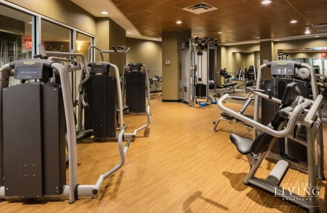 exercise room with a paneled ceiling, visible vents, and recessed lighting