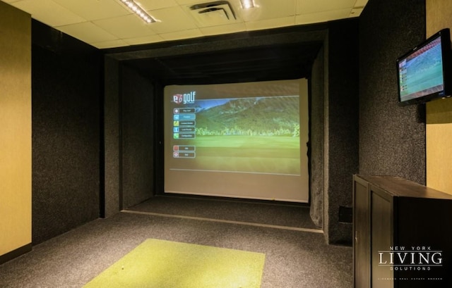 carpeted home theater with visible vents and golf simulator