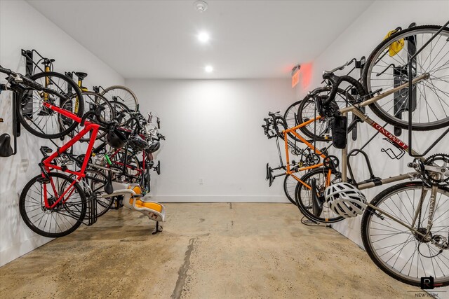 garage featuring baseboards, bike storage, and recessed lighting