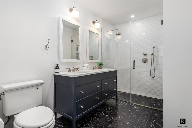 bathroom featuring a sink, a shower stall, and toilet