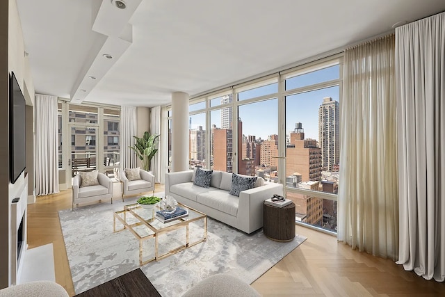 living area featuring a wall of windows and a city view