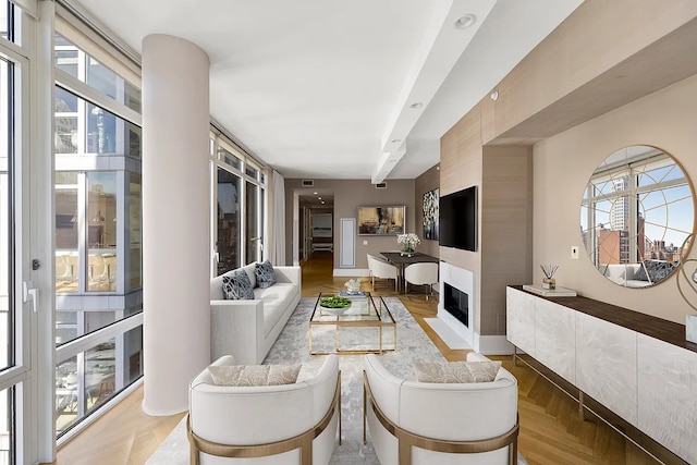 living area with a large fireplace and plenty of natural light