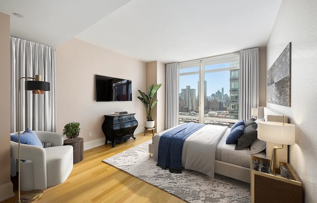 bedroom featuring baseboards and wood finished floors