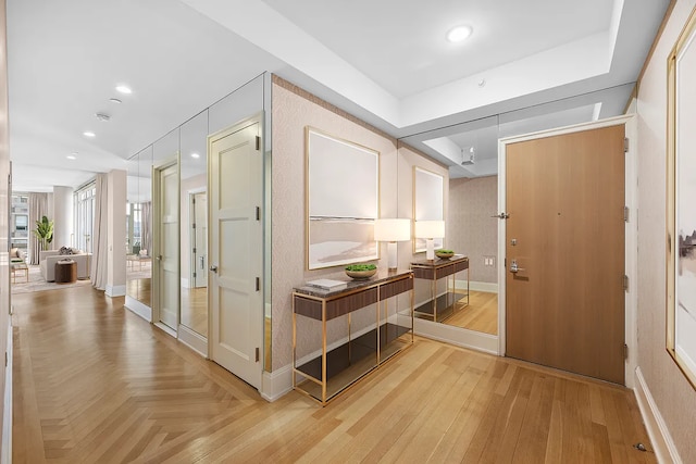 corridor with recessed lighting, baseboards, and parquet flooring