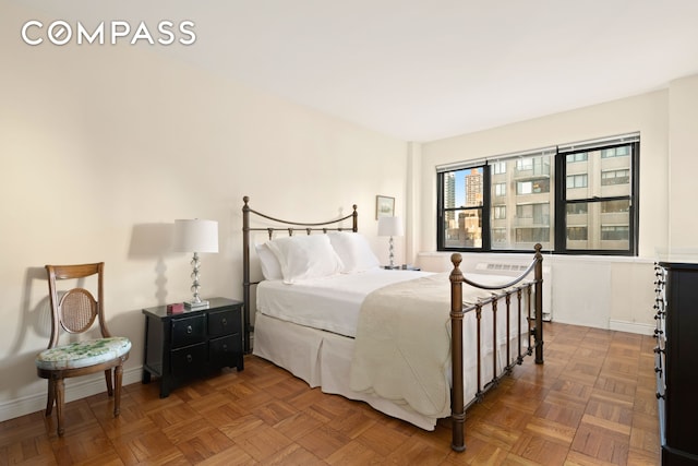 bedroom with baseboards and radiator