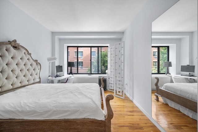 69 E 130th St Unit 2A, New York City, NY 10037 - bedroom with baseboards and light wood-style flooring