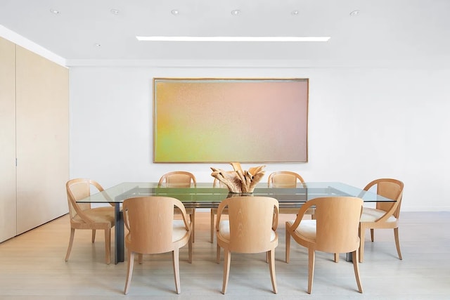 dining space featuring light wood finished floors